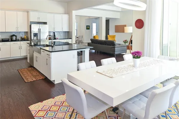 a kitchen with stainless steel appliances granite countertop a sink stove and wooden floor