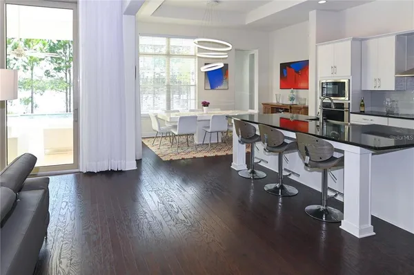 a large kitchen with a table and chairs