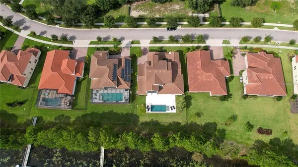 an aerial view of residential house with outdoor space and parking