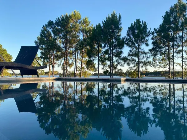 a balcony with wooden floor and lake view