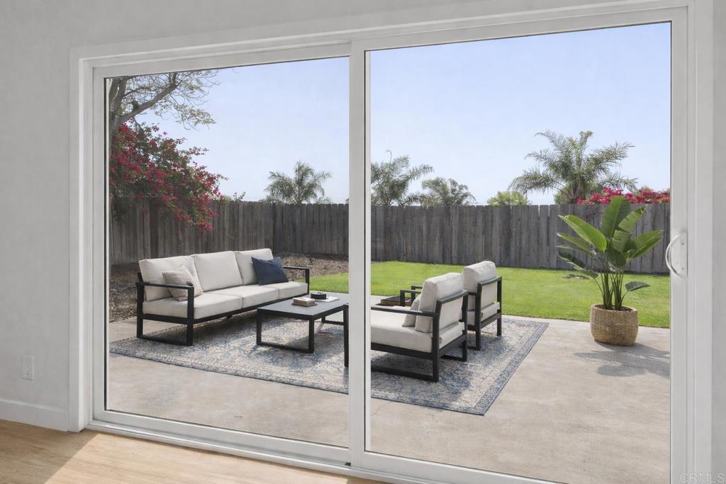 4907 Stephanie Place Oceanside, CA 92057 - Photo 12 of 24 a view of a patio with couches and a table and chairs with potted plants