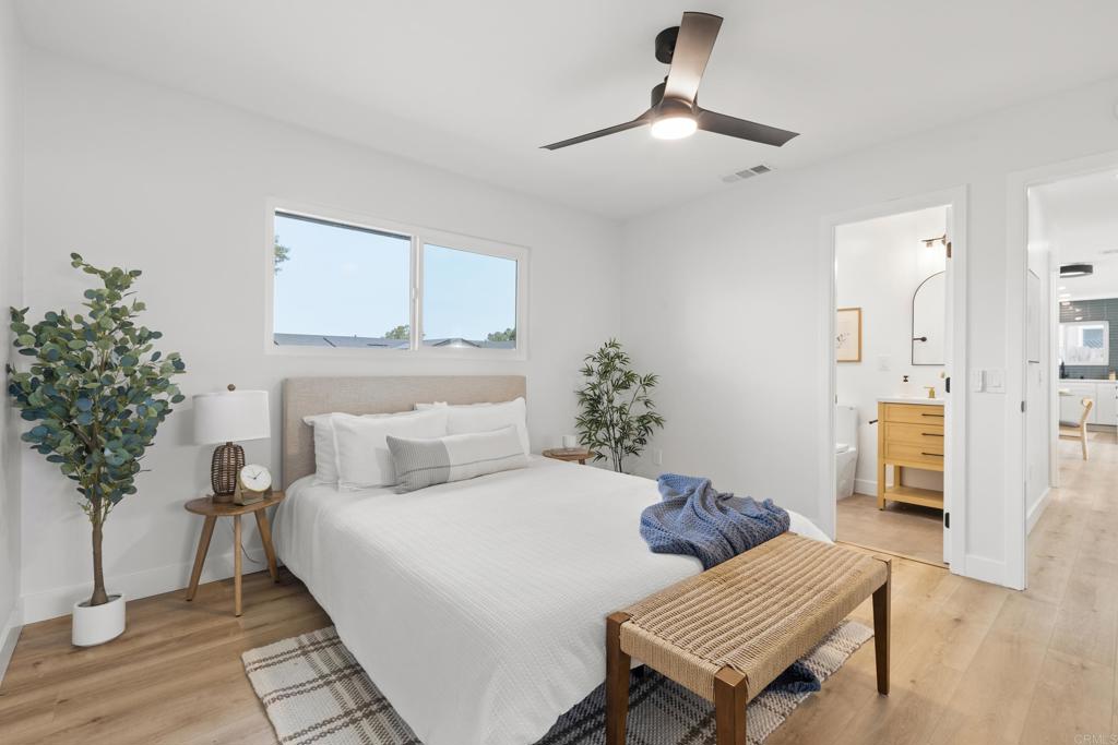 4907 Stephanie Place Oceanside, CA 92057 - Photo 13 of 24 a bedroom with a bed and a potted plant