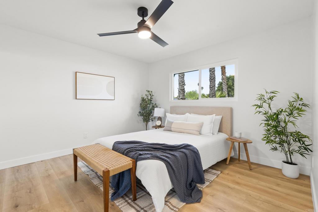 4907 Stephanie Place Oceanside, CA 92057 - Photo 14 of 24 a bedroom with a bed and a potted plant