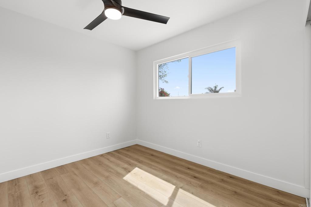 4907 Stephanie Place Oceanside, CA 92057 - Photo 16 of 24 a view of a room with wooden floor and white walls