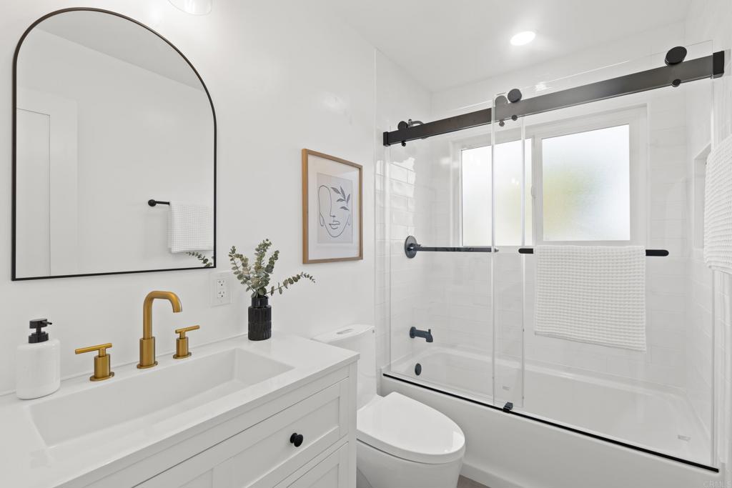 4907 Stephanie Place Oceanside, CA 92057 - Photo 17 of 24 a bathroom with a sink a toilet and shower