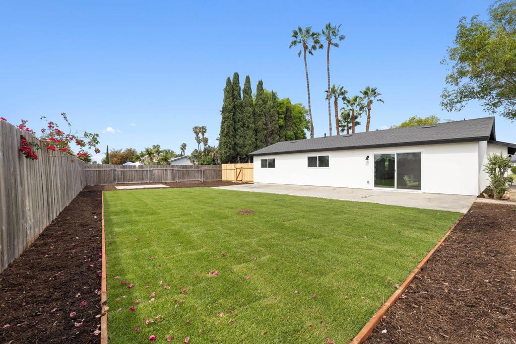 4907 Stephanie Place Oceanside, CA 92057 - Photo 21 of 24 a front view of a house with garden