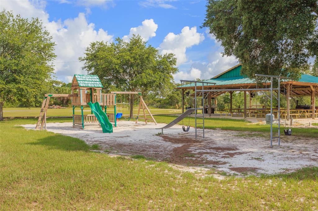Butch Cassidy Trail Wimauma, FL 33598 - Photo 21 of 22 a view of a park with swings and slides