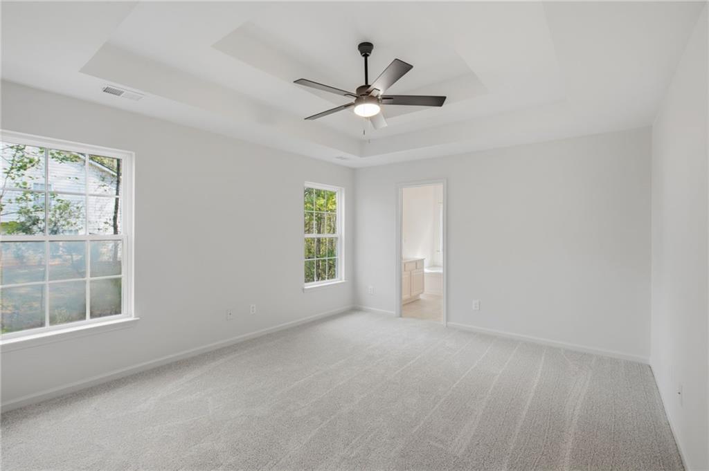 9485 Waldrip Road Gainesville, GA 30506 - Photo 13 of 30 an empty room with a window and ceiling fan