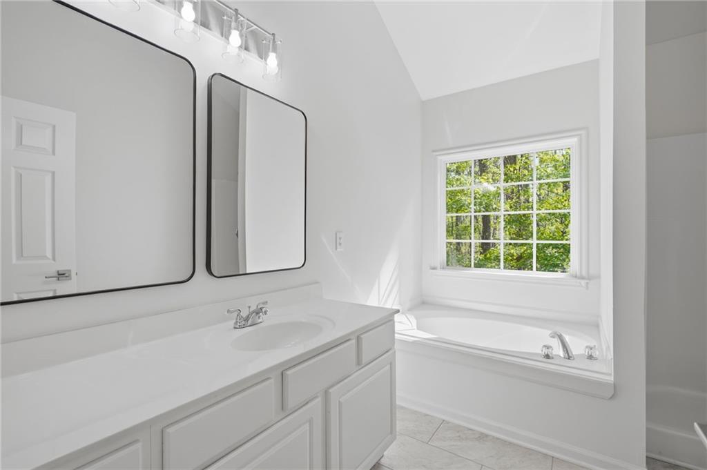 9485 Waldrip Road Gainesville, GA 30506 - Photo 14 of 30 a bathroom with a bathtub and a sink