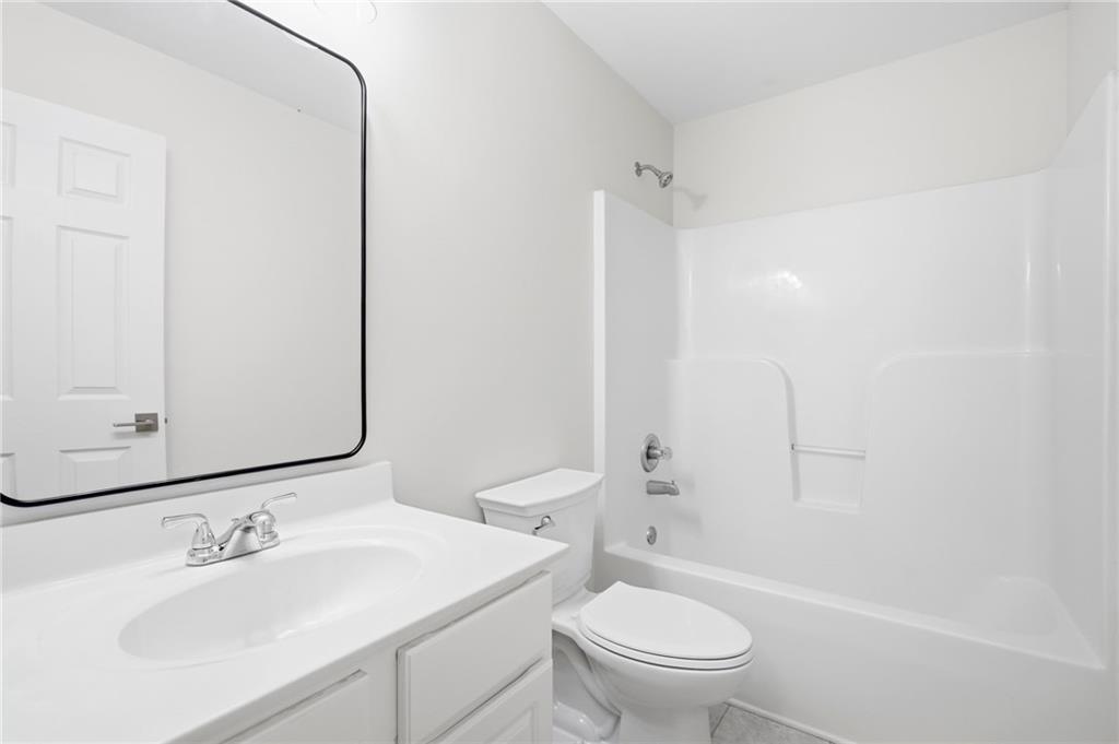 9485 Waldrip Road Gainesville, GA 30506 - Photo 18 of 30 a bathroom with a sink toilet and shower
