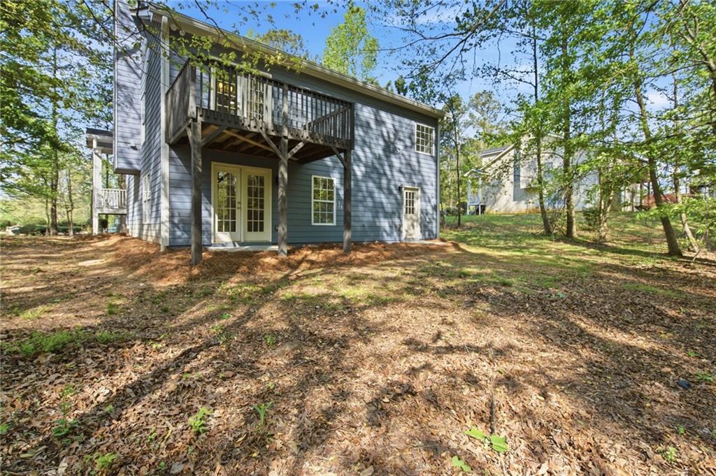 9485 Waldrip Road Gainesville, GA 30506 - Photo 25 of 30 a view of a brick house with a large tree
