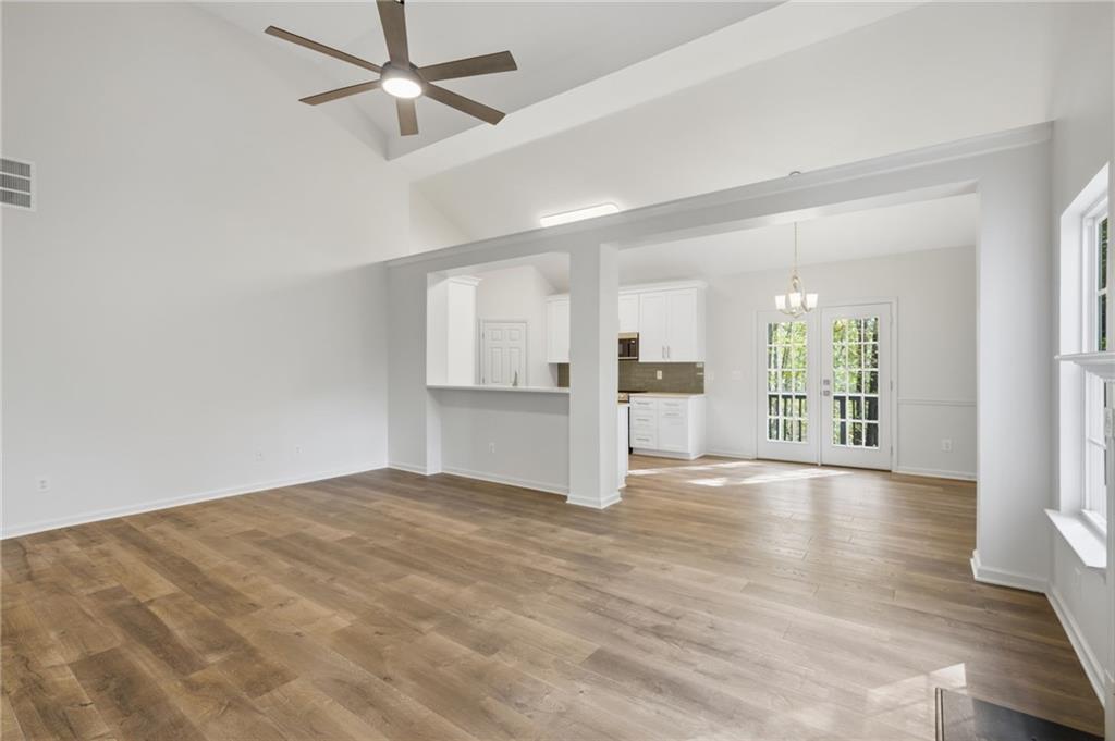 9485 Waldrip Road Gainesville, GA 30506 - Photo 4 of 30 a view of an empty room with window and wooden floor