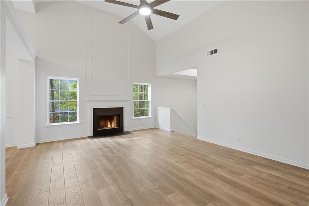 9485 Waldrip Road Gainesville, GA 30506 - Photo 5 of 30 an empty room with windows and a fireplace