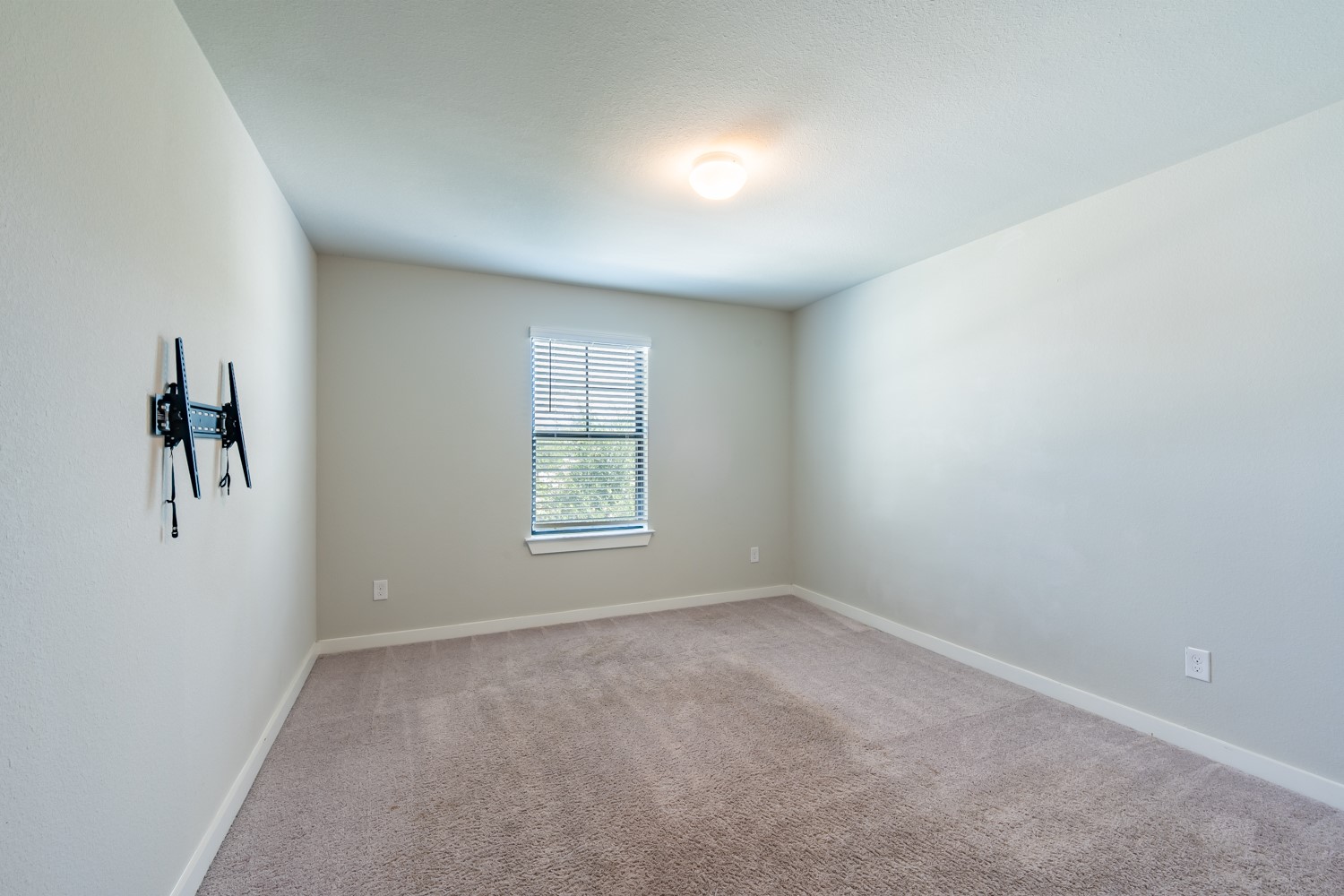 147 Waterside Road, Unit A Buda, TX 78610 - Photo 20 of 27 A well-proportioned interior with plush carpeting and natural illumination from a window.