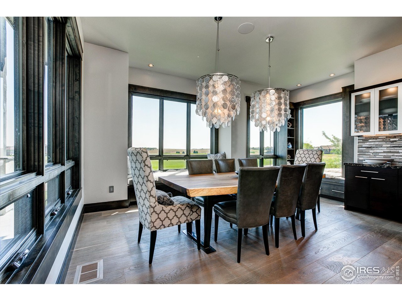 6438 Sanctuary Drive Windsor, CO 80550 - Photo 13 of 40 a view of a dining room with furniture window and wooden floor