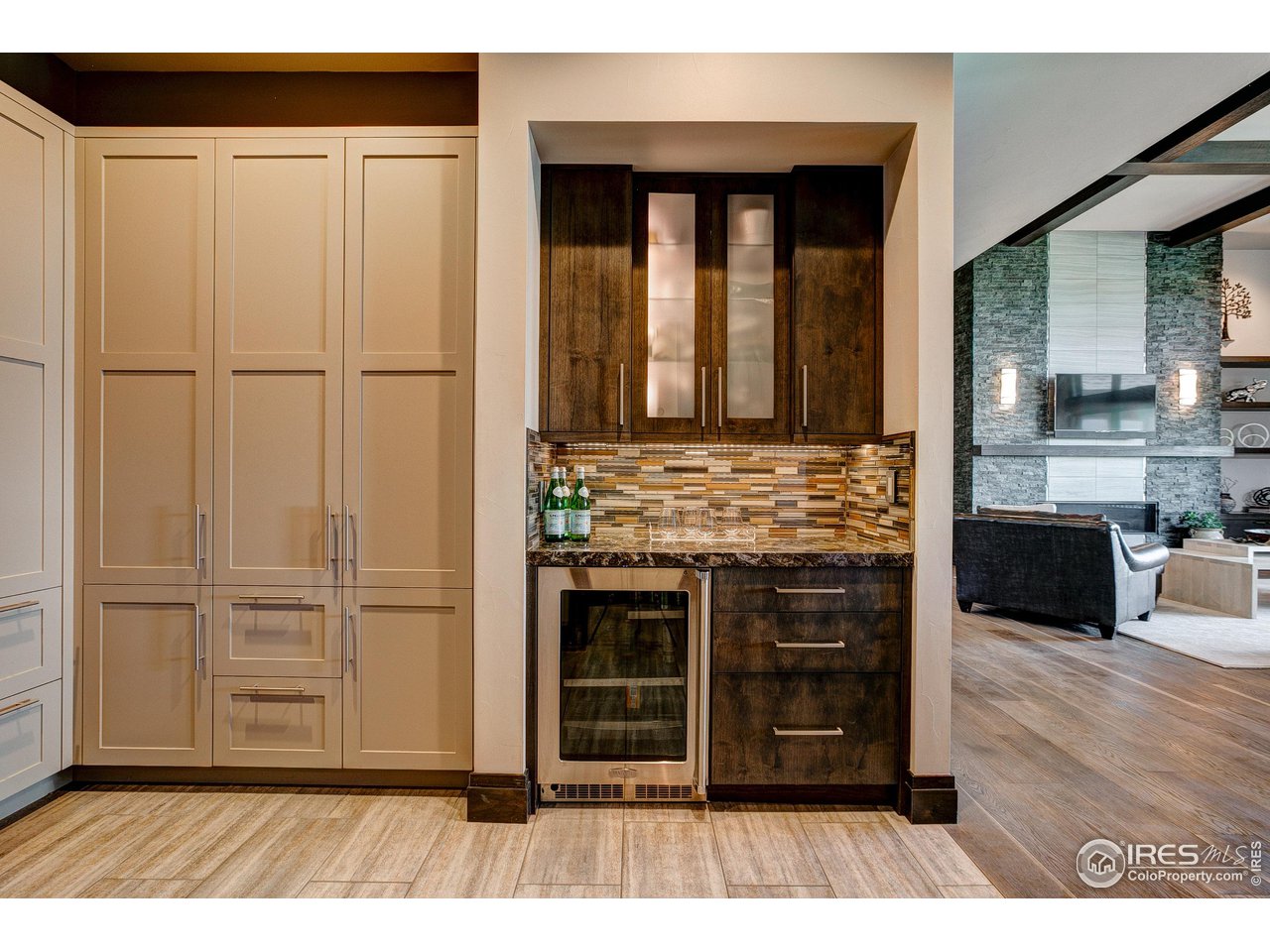 6438 Sanctuary Drive Windsor, CO 80550 - Photo 15 of 40 a view of a hallway with wooden floor and cabinet