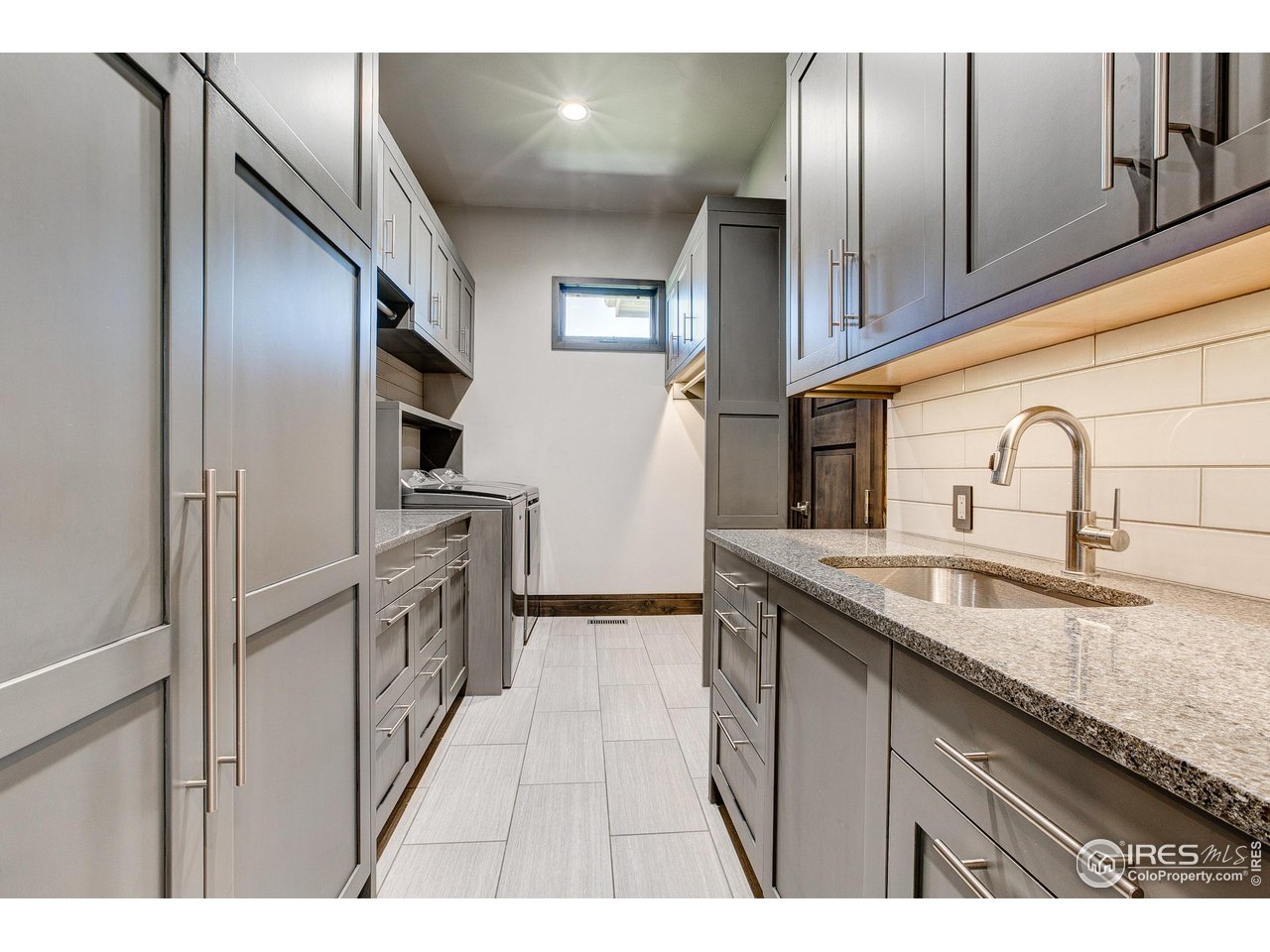 6438 Sanctuary Drive Windsor, CO 80550 - Photo 20 of 40 a kitchen with stainless steel appliances granite countertop a sink and refrigerator