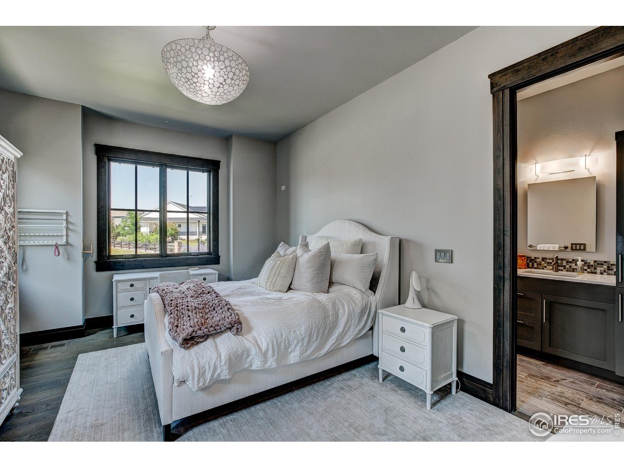 6438 Sanctuary Drive Windsor, CO 80550 - Photo 22 of 40 a bedroom with a bed and a window