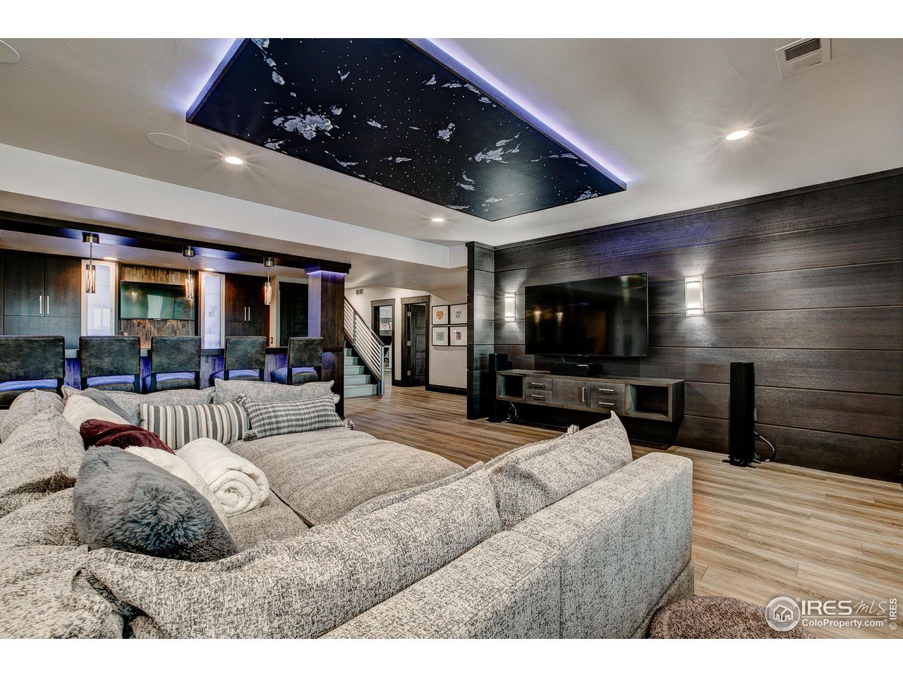 6438 Sanctuary Drive Windsor, CO 80550 - Photo 25 of 40 a living room with furniture and a flat screen tv