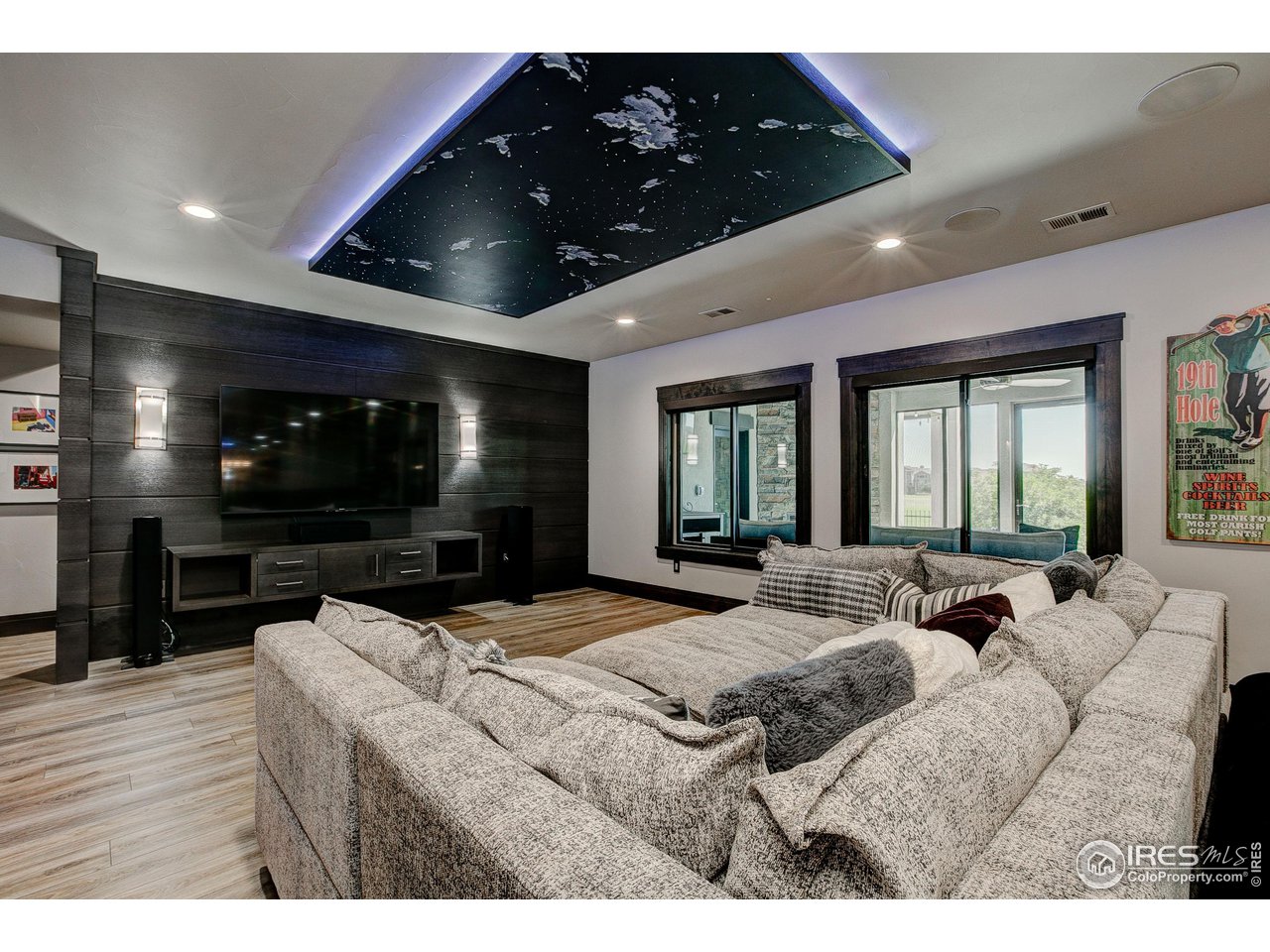 6438 Sanctuary Drive Windsor, CO 80550 - Photo 26 of 40 a living room with furniture and a flat screen tv