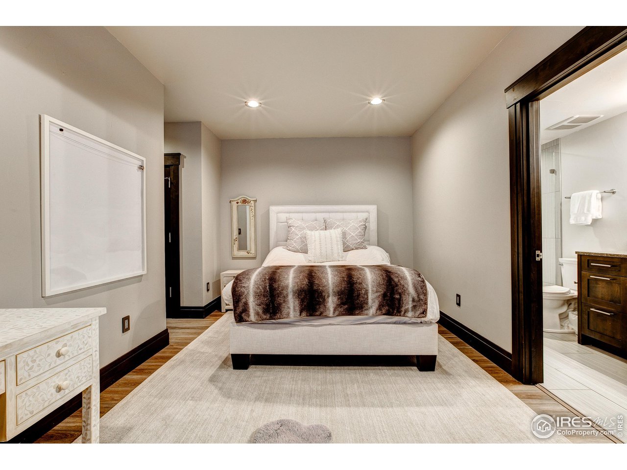 6438 Sanctuary Drive Windsor, CO 80550 - Photo 31 of 40 a bedroom with a bed and a window