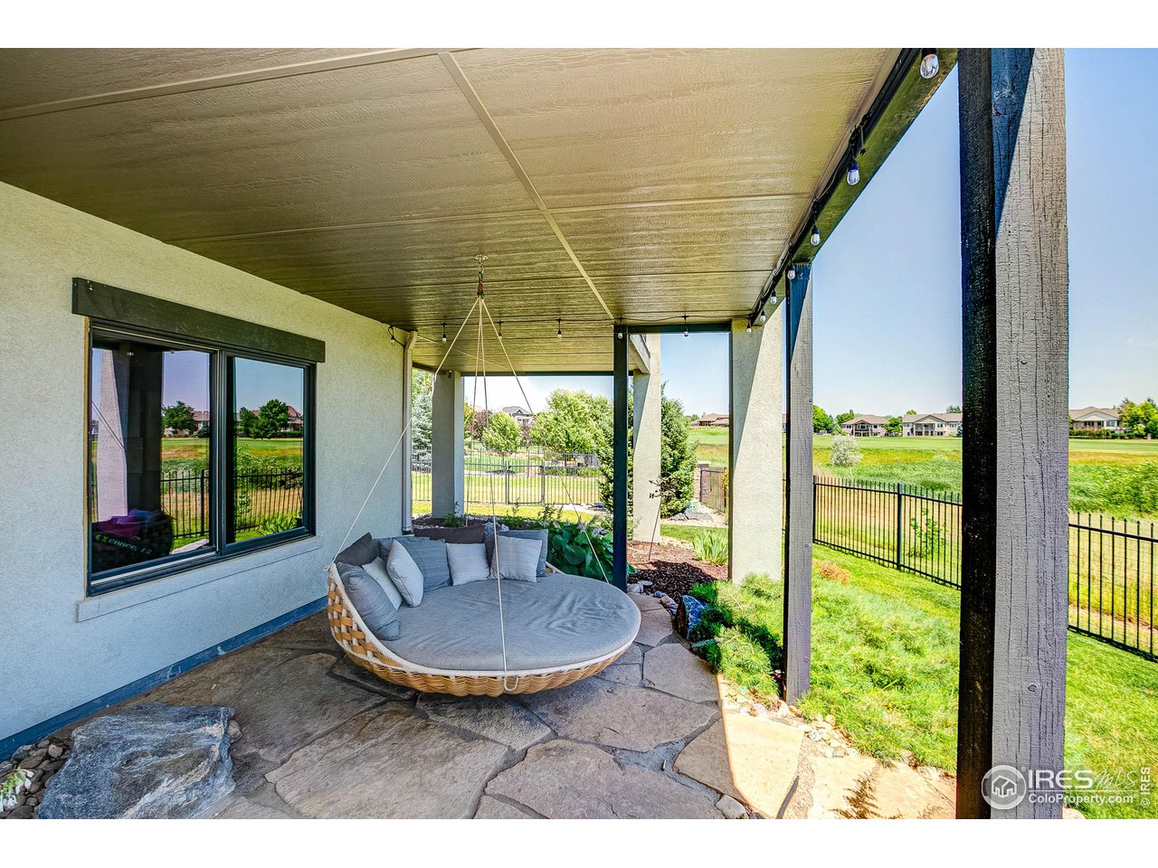 6438 Sanctuary Drive Windsor, CO 80550 - Photo 34 of 40 a view of a porch with furniture and yard