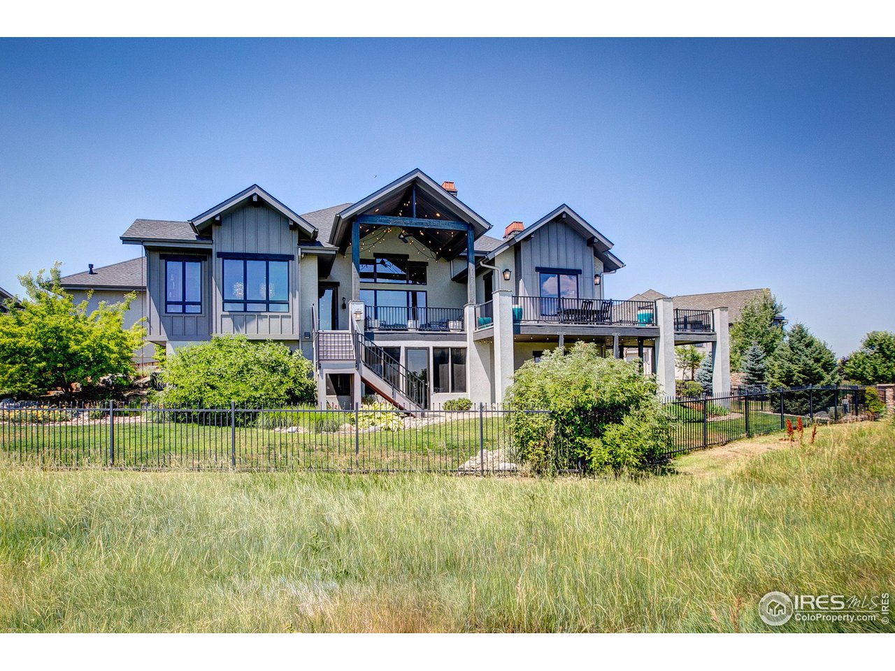 6438 Sanctuary Drive Windsor, CO 80550 - Photo 38 of 40 a front view of a house with a yard