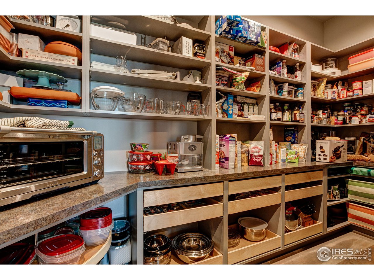 6438 Sanctuary Drive Windsor, CO 80550 - Photo 10 of 40 a room with lots of books and a fireplace