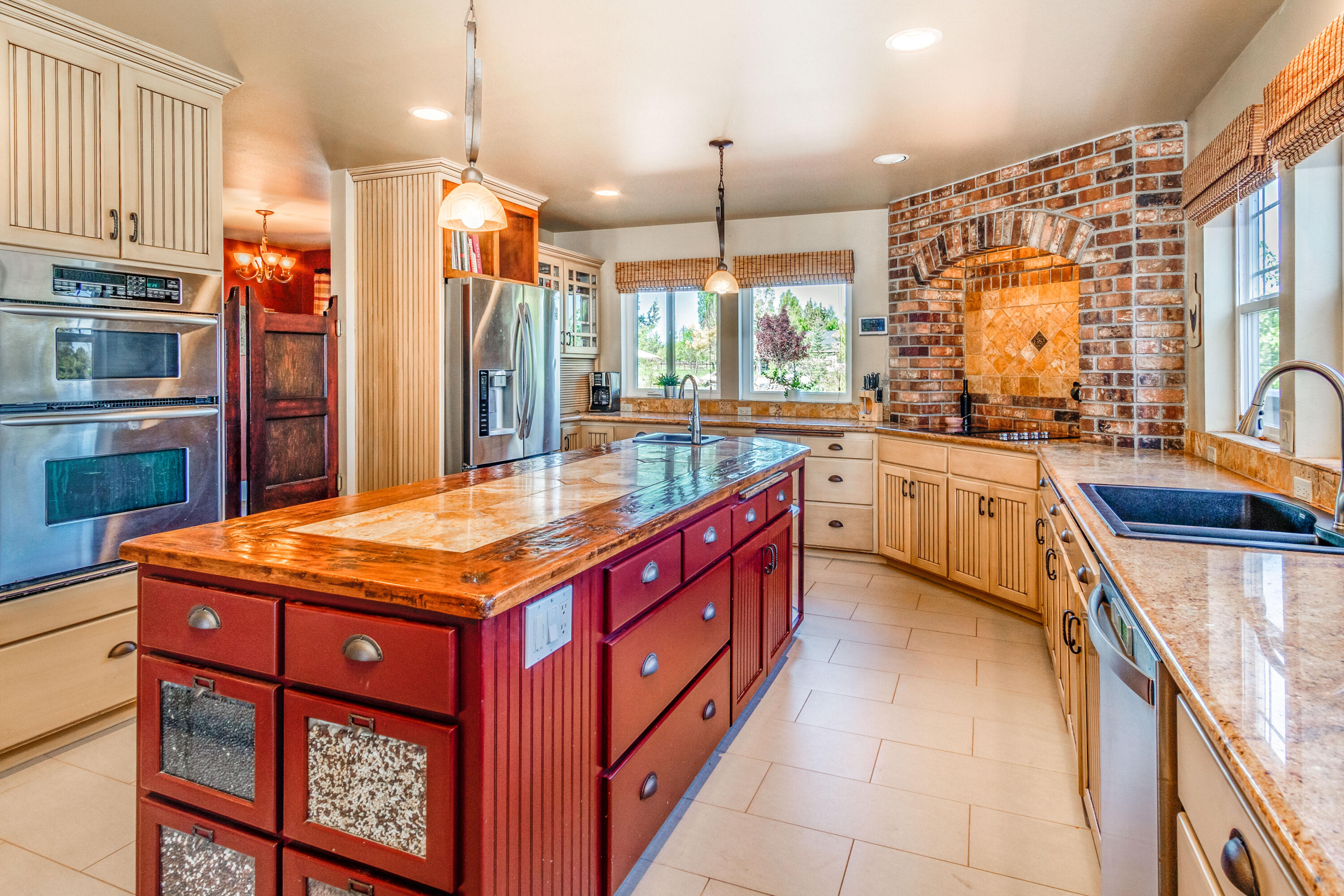 22234 Nelson Road Bend, OR 97701 - Photo 6 of 60 a kitchen with stainless steel appliances granite countertop a stove a sink dishwasher and a refrigerator