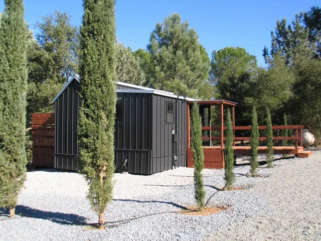 a view of backyard with seating space and trees