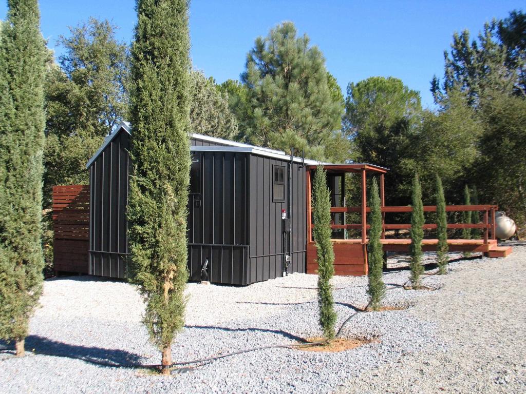 a view of backyard with seating space and trees