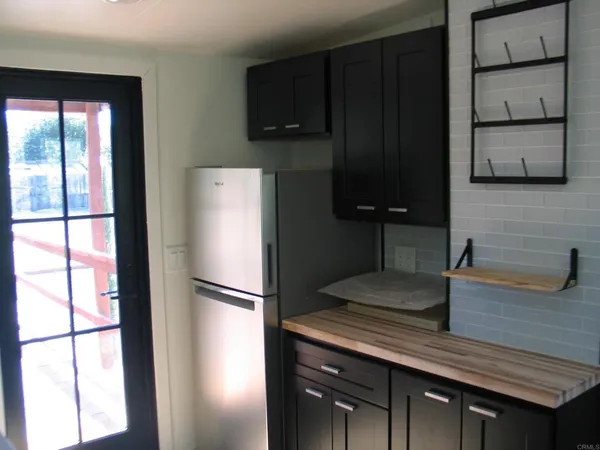 a kitchen with a refrigerator and a sink