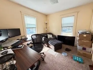 a bedroom with furniture and a window