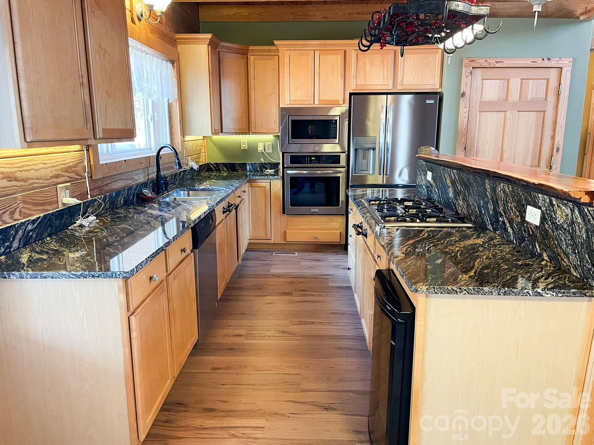 143 Rosewood Lane Rutherfordton, NC 28139 - Photo 20 of 47 a kitchen with stainless steel appliances granite countertop a stove a sink and a refrigerator