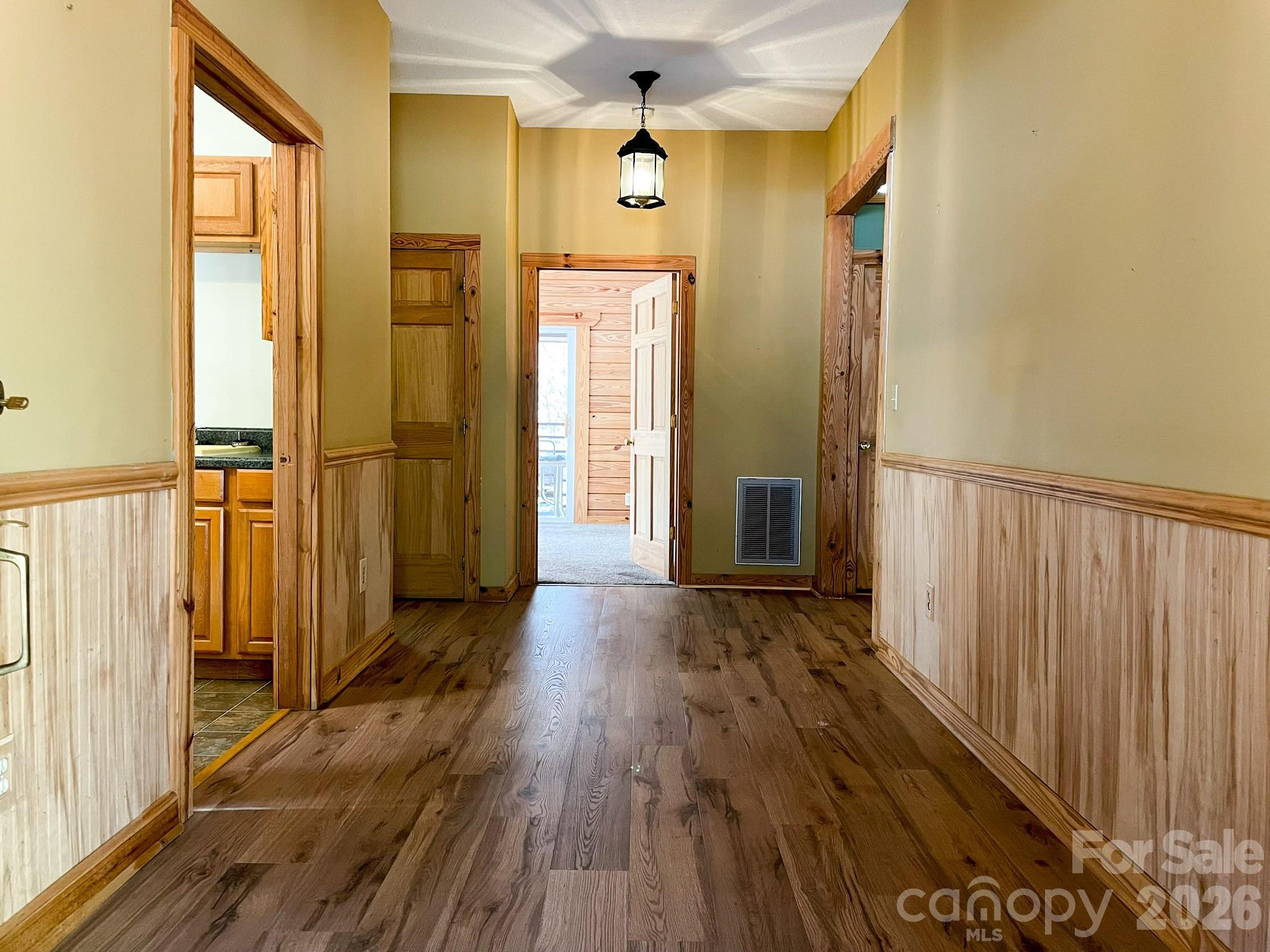 143 Rosewood Lane Rutherfordton, NC 28139 - Photo 9 of 47 a view of a hallway with wooden floor and staircase