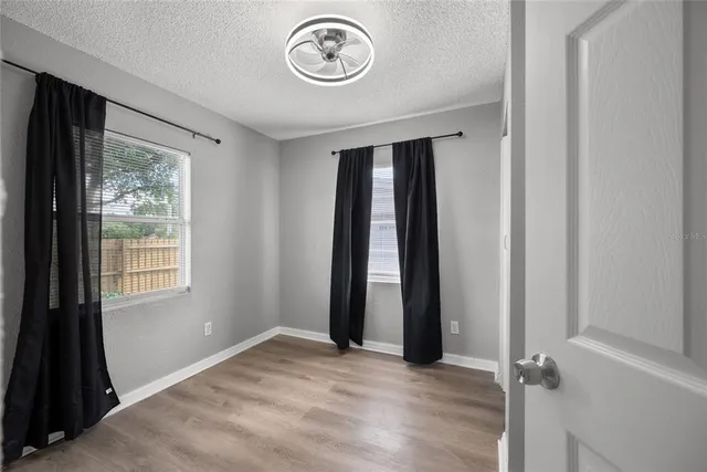 an empty room with a door and a window