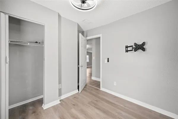 a view of an empty room with wooden floor