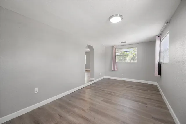 wooden floor in an empty room with a window