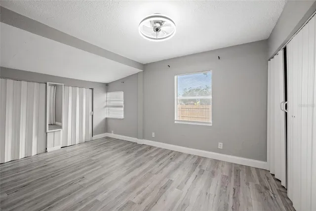 a view of a room with wooden floor and window