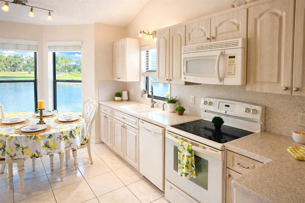 3637 Downfield Place, Unit 402 New Port Richey, FL 34655 - Photo 15 of 39 a kitchen that has a sink and chairs in it