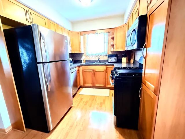 a kitchen with stainless steel appliances a refrigerator and a stove