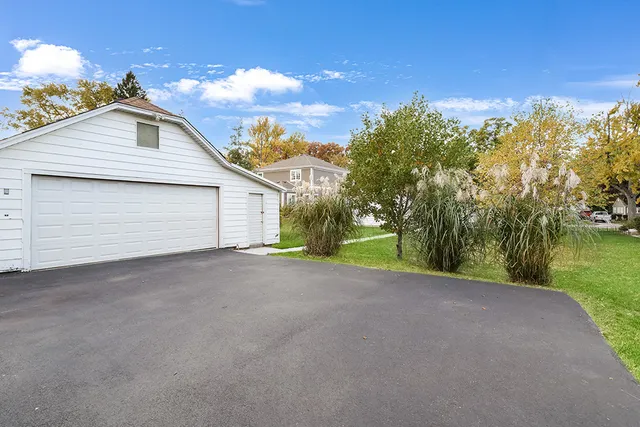 a view of a house with a yard and garage
