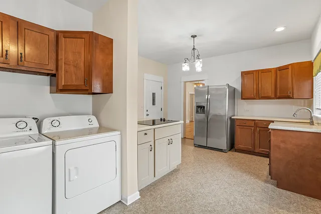 a kitchen with refrigerator cabinets and a sink