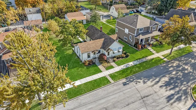 an aerial view of a house with a garden and trees