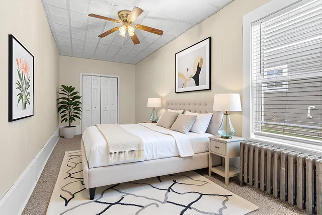 a bedroom with a bed and a chandelier