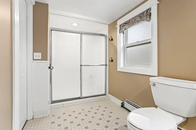 a white toilet sitting next to a bathroom sink