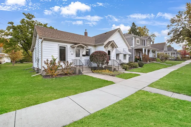 a front view of house with yard and green space