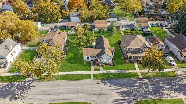 an aerial view of a houses with yard