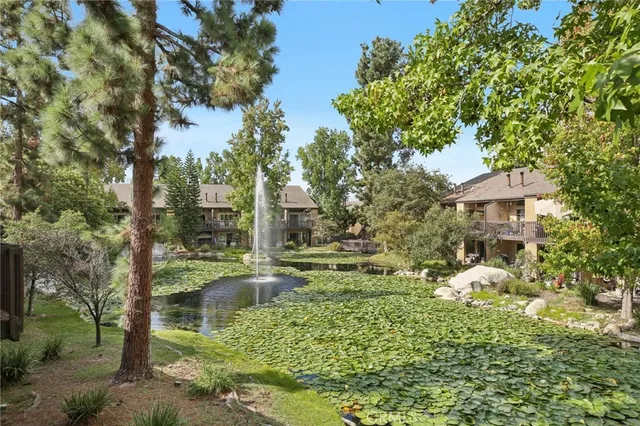 a backyard of a house with a yard and outdoor seating