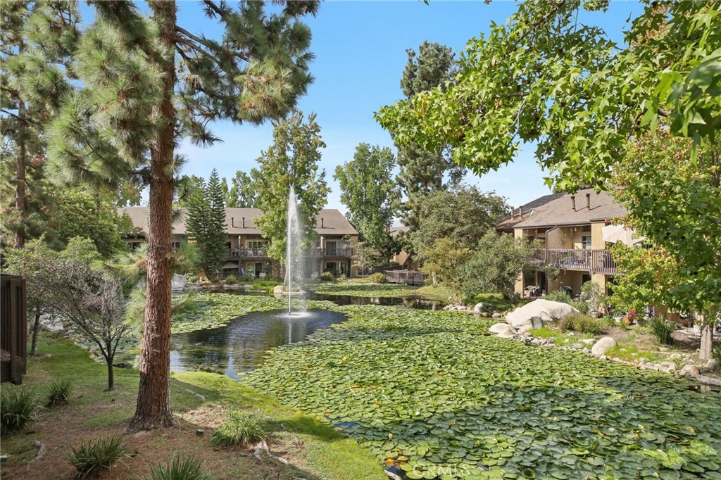 7890 East Spring Street, Unit 16P Long Beach, CA 90815 - Photo 19 of 25 a backyard of a house with a yard and outdoor seating